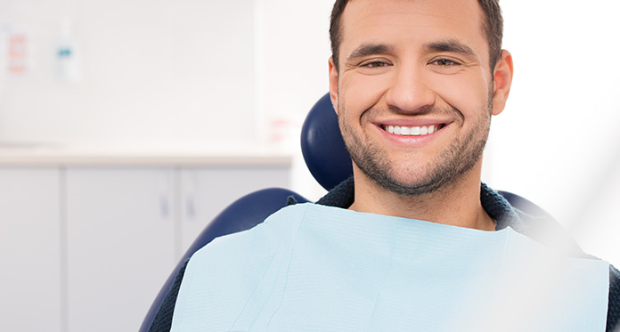 Man Smiling in Dental Chair